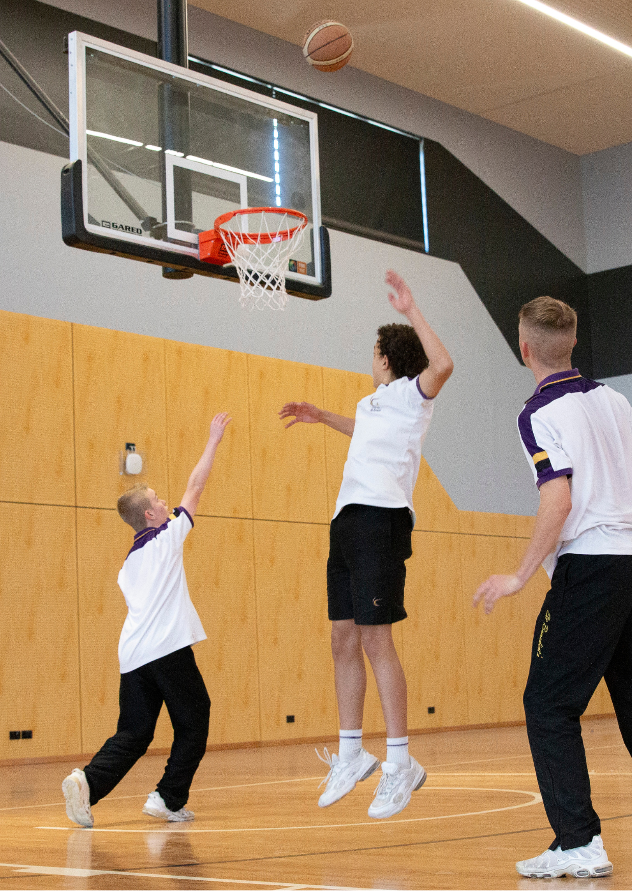 Students playing Basketball in the St Benedict's Catholic College Hall
